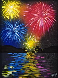 fireworks are lit up in the night sky over water with reflections on the surface and reflecting off