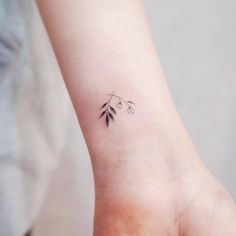 a small tattoo on the wrist of a woman