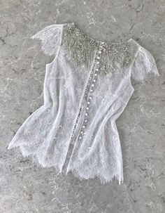 Elegant Fitted Tops For Weddings, Elegant Pearl-embellished Blouse For Wedding, Elegant Wedding Lace With Lace Bodice, Elegant White Tops With Delicate Lace, Fitted Lace Top With Lace Bodice For Wedding, Fitted Lace Top For Wedding, Elegant White Lace Top For Wedding Night, Elegant Embellished Blouse For Wedding, Fitted Elegant Blouse With Pearl Embroidery