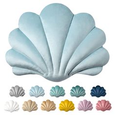 various colors of scallop shell shaped pillows in different sizes and shapes, all on white background