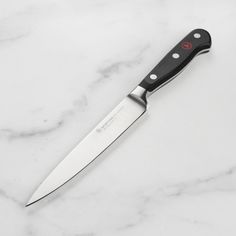 a large knife sitting on top of a white counter