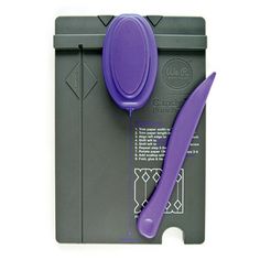 a purple spatula sitting on top of a gray cutting board next to a knife