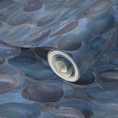 an abstract blue and grey wallpaper with circles on it's surface, in the middle