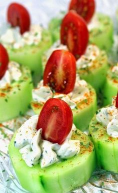 cucumber and tomato appetizers with sour cream on them are ready to be eaten