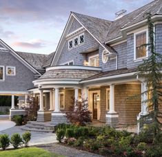 a large house with lots of windows in the front yard