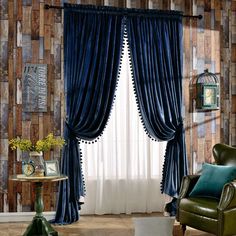 a living room filled with furniture and a window covered in blue curtains