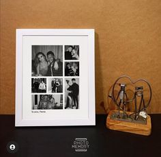 a black and white photo is next to a couple's wedding rings on a table