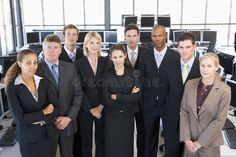 a group of business people standing in an office