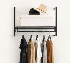 a rack with clothes and hats hanging on it