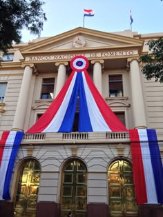 the entrance to an old building decorated in red, white and blue