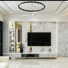 an elegant living room with marble walls and flooring, white couches and a flat screen tv mounted on the wall