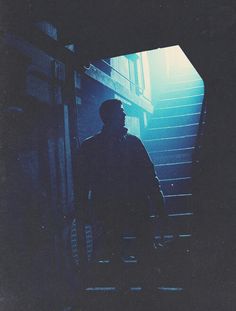 a man walking up some stairs in the dark