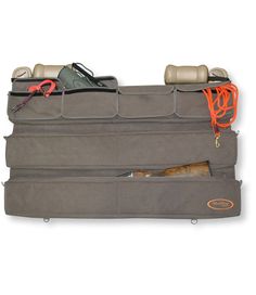 Keep all your gear securely behind your truck or SUV seat. This roomy organizer is perfect for hunting gear, dog-training accessories, fishing equipment and much more. Durable nylon/polyester pique blend. Includes: four large accessory pockets. And two padded gun cases that accommodate shotguns up to 48 inches long. Bottom gun case is detachable so you can use it as a field gun case. Bungee for attaching to seat included. Imported. | Truck Seat Gun Case Organizer, Nylon Truck Seat Organizer, Hunting Storage, Truck Organization, Truck Storage, Gear Organizer, Hunting Gear, Fishing Equipment, Fishing Gear, Cool Trucks