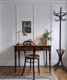 an instagram photo of a desk and chair in a room with white walls, wood floors and wooden flooring