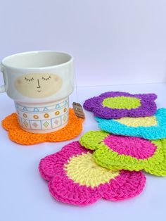 crocheted coasters and a mug on a table