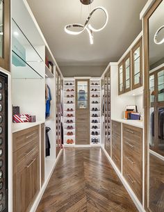 a large walk in closet with wooden floors