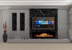 a living room with a fireplace and large screen tv on it's wall, surrounded by candles