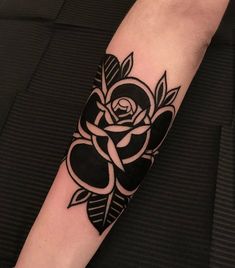 a black and white rose tattoo on the arm