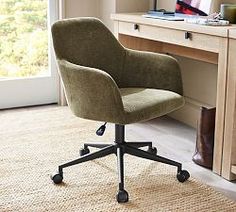 an office chair sitting in front of a computer desk