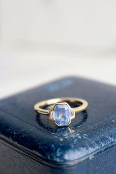 a blue ring sitting on top of a case