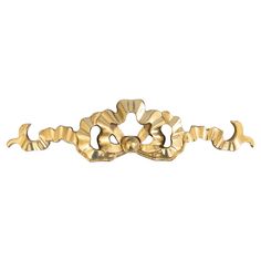 an ornate gold handle on a white background