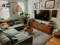 a living room filled with furniture and a large flat screen tv mounted on the wall