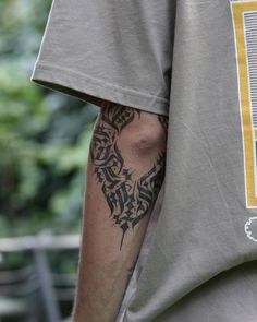 a man with a tattoo on his arm