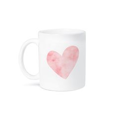 a white coffee mug with a pink heart on the front and bottom, against a white background