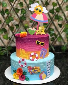 a multi layer cake decorated with colorful decorations