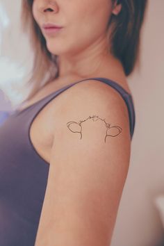 a woman with a small tattoo on her arm