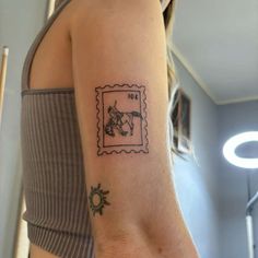 a woman with a small tattoo on her arm