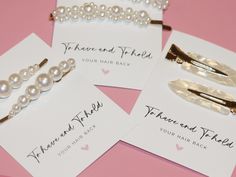 four pairs of hair clips with pearls on them