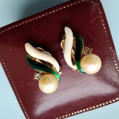 Thank you for visiting the SoChicFinds store - vintage and antique, costume and fine jewelry.   This is a pair enamel clip on earrings with pearls and rhinestones. Color: gold, creamy, green.  Measure: 1  x 5/8 inches. Faux pearl clip on earrings in excellent condition. Vintage costume jewelry from 1980s. Feel free to ask questions, I'll be happy to answer them. Cream and Green Enamel Faux Pearl Clip on Earrings, Rhinestone Earring for Women,  Gold Tone Costume Vintage 1980s Jewelry 50s Jewelry, 1980s Jewelry, Compass Pendant, Cute Rings, Green Enamel, Rhinestone Earrings, Vintage Costume Jewelry, Vintage Costumes, Gold Tone Metal