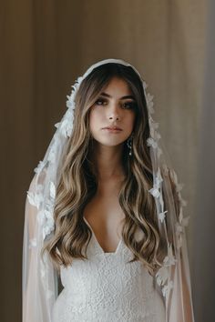 a woman wearing a veil and wedding dress