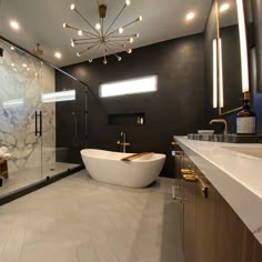 a bathroom with a large bathtub, sink and shower stall in it's center