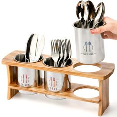 a wooden stand holding silverware and utensils on it's sides,