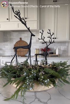 a christmas centerpiece in the shape of a deer and antlers on a kitchen counter