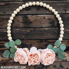 the necklace has three roses on it and is attached to a white beaded bracelet