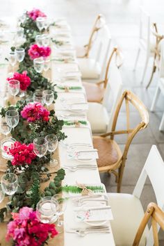 a long table is set with flowers and place settings