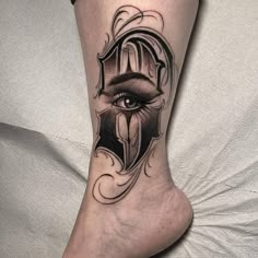 a person's leg with a tattoo on it and an eye in the center