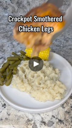 a white plate topped with mashed potatoes and green beans next to corn on the cob