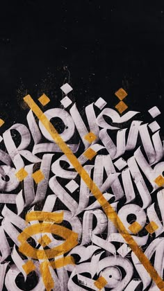 graffiti written in yellow and white letters on a black background with an arrow pointing to the left