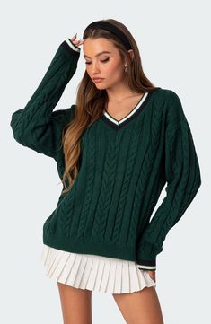 Classic cables and striped trim prep up this sweater knit from supersoft yarns in an oversized fit that layers over your tennis togs or anything else. V-neck Long sleeves with ribbed cuffs 100% Acrilan acrylic Hand wash, dry flat Imported Cable Knit Sweater Womens, Cable Sweater, Swimwear Dress, Cable Knit Sweater, Green Sweater, Sweater Knit, S Models, Set Dress, Womens Clothing Tops