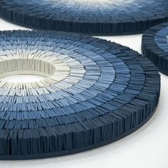 three blue and white plates sitting on top of a table