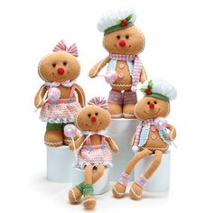 four teddy bears dressed in different outfits sitting on top of a white container with candy