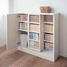 a book shelf with several books and a basket on top