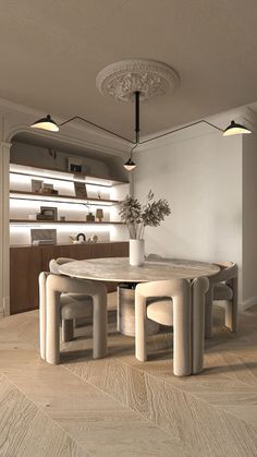 a table and chairs in a room with wood flooring