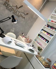 a beauty salon with various products on the counter and shelves full of nail polishes