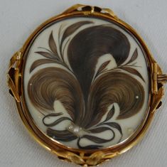 The design is made of human hair. It is a pendant, with human hair pressed under glass. The hair was probably from a deceased loved one (or several). Victorian Curiosities, George And Martha, Hair Jewerly, Victorian Hair, Martha Washington, Victorian Hairstyles, Georgian Jewelry, Jewelry Casket