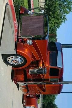 an orange truck parked next to a building